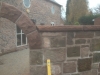 Red sandstone saddleback copings capping a boundary wall