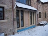 Sandstone door surround with a hood mould