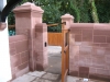 Buff sandstone gatepost with a moulded cap