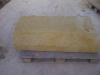 Mason hand-tooling a sandstone block
