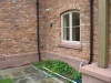 Sandstone plinth course on a new build