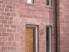 Hand-tooled sandstone quoins on a building corner