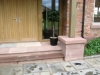 Buff sandstone staddle stone shaped for an oak-framed building