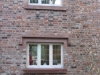 Red sandstone window surround by JB Stone